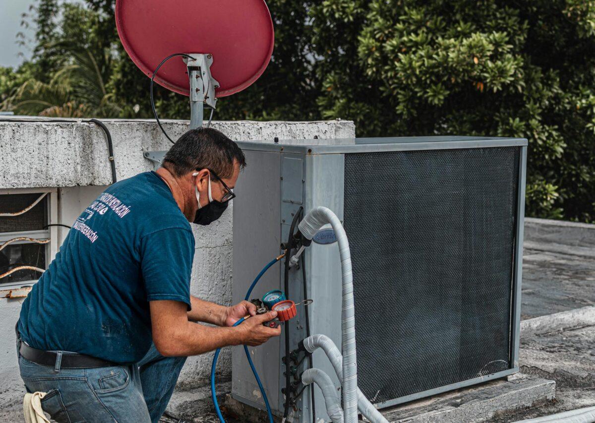 HVAC technician installing a central air conditioning unit in a Calgary home